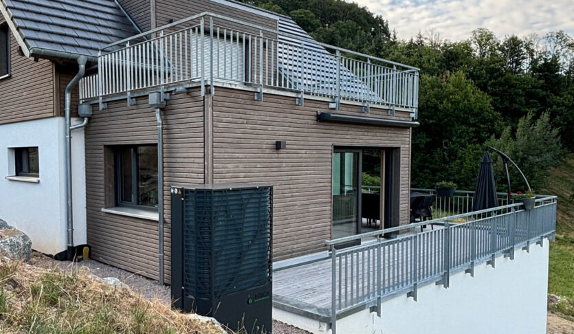 Waermepumpe 10 kW vor Einfamilienhaus mit Fussbodenheizung